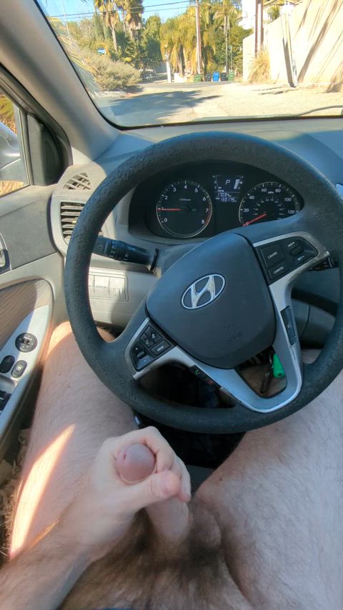 Pounding my cock hard in the driver's seat.