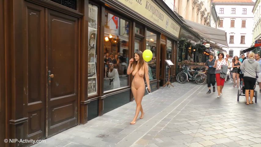 Brave Stella Cox walking through a European market naked